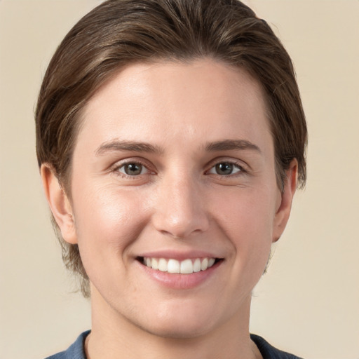 Joyful white young-adult female with short  brown hair and grey eyes