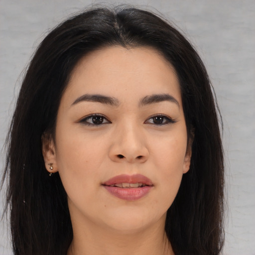 Joyful asian young-adult female with long  brown hair and brown eyes