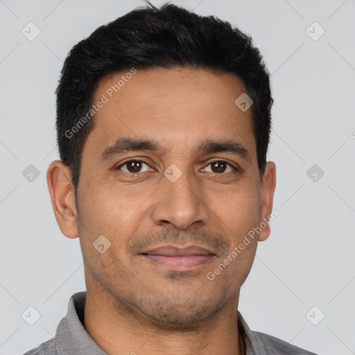 Joyful latino young-adult male with short  black hair and brown eyes