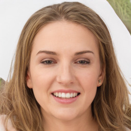 Joyful white young-adult female with long  brown hair and green eyes