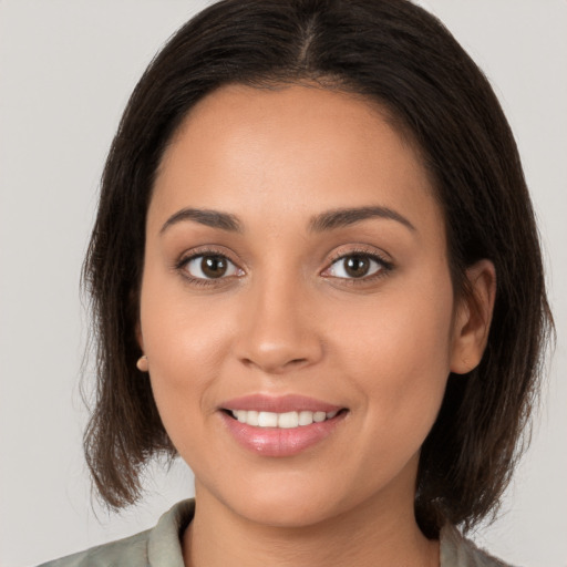 Joyful white young-adult female with long  brown hair and brown eyes