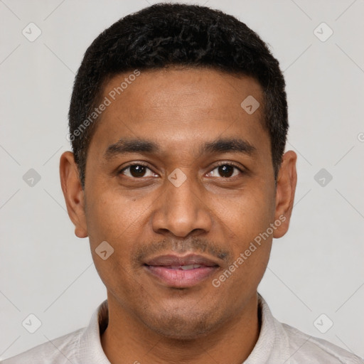 Joyful latino young-adult male with short  black hair and brown eyes