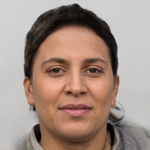 Joyful white adult female with short  brown hair and brown eyes