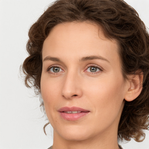 Joyful white young-adult female with medium  brown hair and green eyes