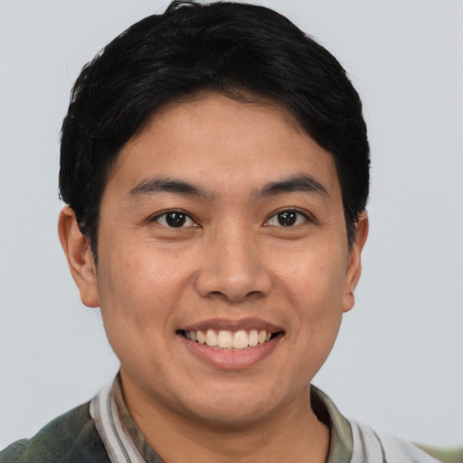 Joyful asian young-adult male with short  black hair and brown eyes