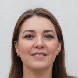 Joyful white young-adult female with long  brown hair and grey eyes