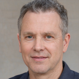 Joyful white middle-aged male with short  brown hair and grey eyes