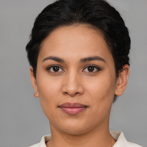 Joyful latino young-adult female with short  brown hair and brown eyes