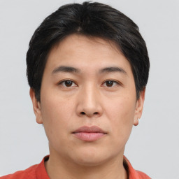 Joyful asian young-adult male with short  brown hair and brown eyes