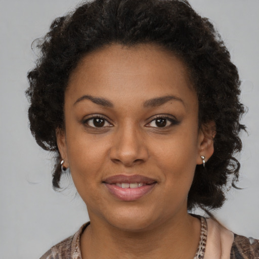 Joyful black young-adult female with medium  brown hair and brown eyes