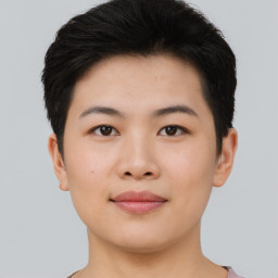 Joyful asian young-adult female with short  black hair and brown eyes