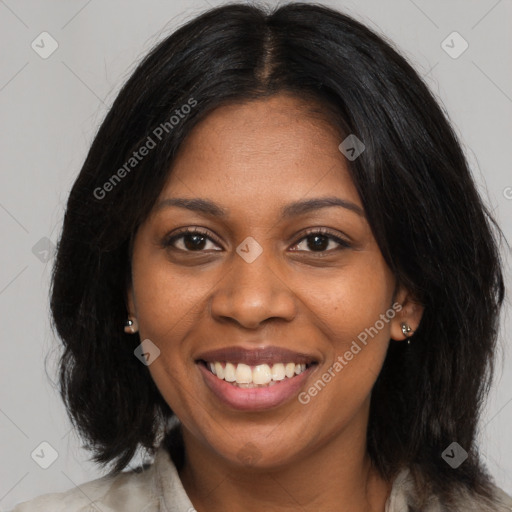 Joyful black young-adult female with long  black hair and brown eyes