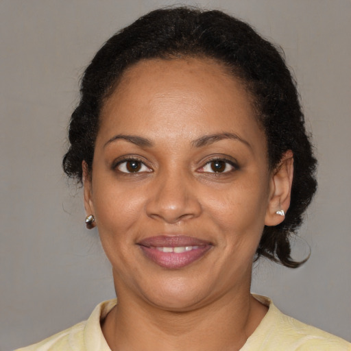 Joyful black adult female with short  brown hair and brown eyes