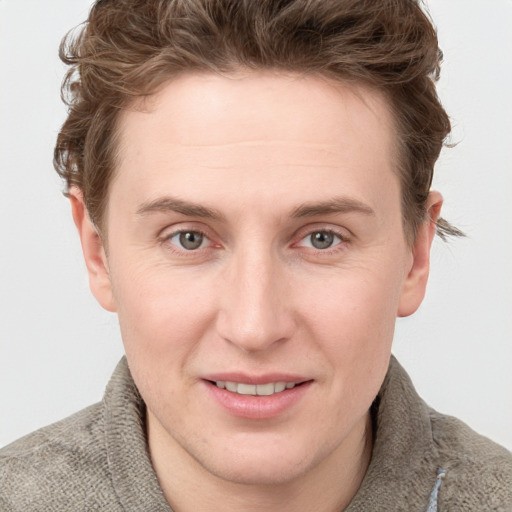 Joyful white young-adult male with short  brown hair and blue eyes