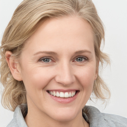 Joyful white young-adult female with medium  brown hair and blue eyes