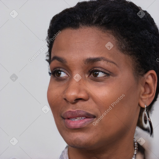 Joyful black young-adult female with short  black hair and brown eyes