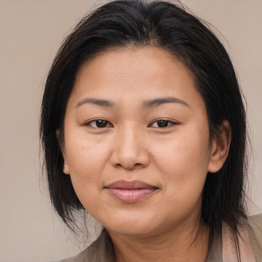 Joyful latino adult female with medium  brown hair and brown eyes