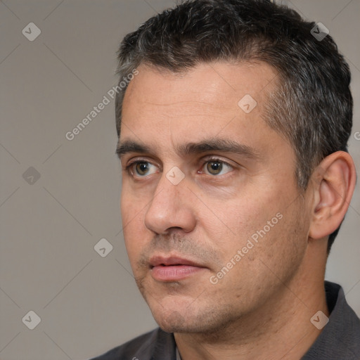 Joyful white adult male with short  black hair and brown eyes