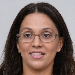 Joyful white adult female with long  brown hair and grey eyes