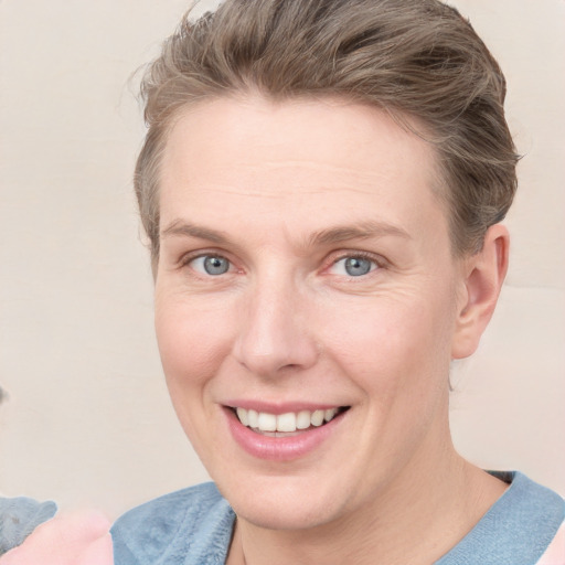 Joyful white adult female with short  brown hair and grey eyes