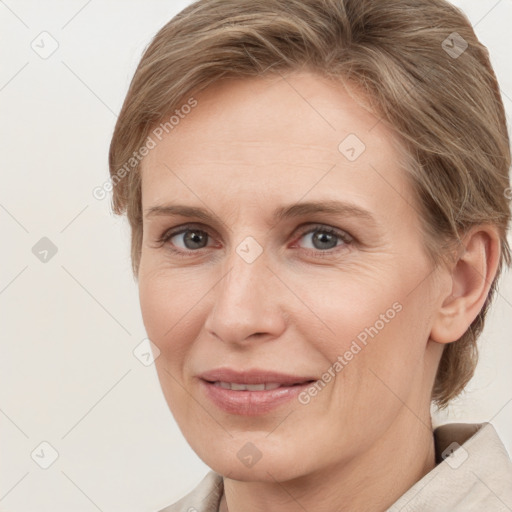 Joyful white adult female with medium  brown hair and grey eyes