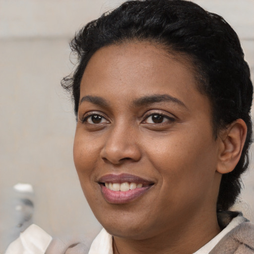 Joyful latino young-adult female with short  black hair and brown eyes