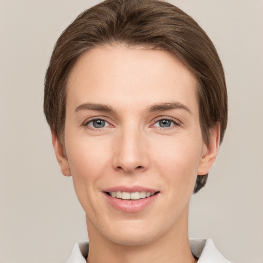 Joyful white young-adult female with short  brown hair and grey eyes