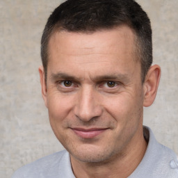 Joyful white adult male with short  brown hair and brown eyes