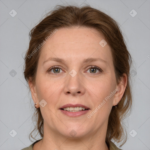 Joyful white adult female with medium  brown hair and grey eyes