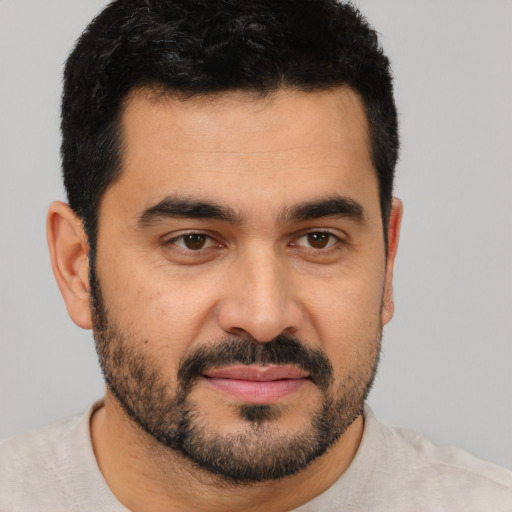 Joyful latino young-adult male with short  black hair and brown eyes