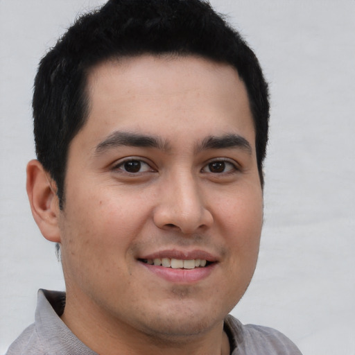 Joyful latino young-adult male with short  brown hair and brown eyes