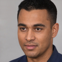 Joyful white young-adult male with short  black hair and brown eyes