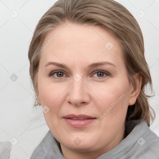 Joyful white adult female with medium  brown hair and blue eyes