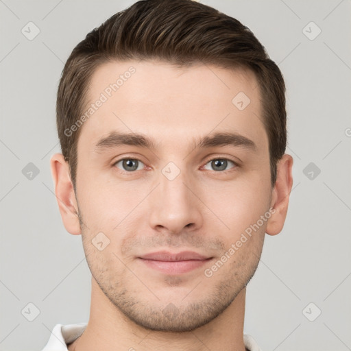 Joyful white young-adult male with short  brown hair and grey eyes