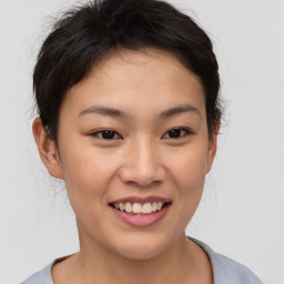 Joyful asian young-adult female with short  brown hair and brown eyes