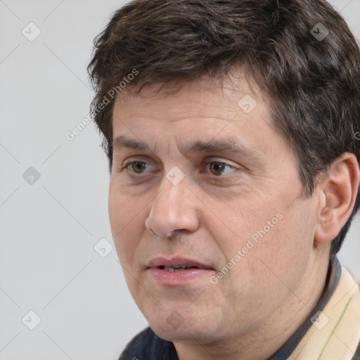 Joyful white adult male with short  brown hair and brown eyes