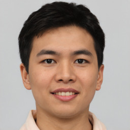 Joyful asian young-adult male with short  brown hair and brown eyes