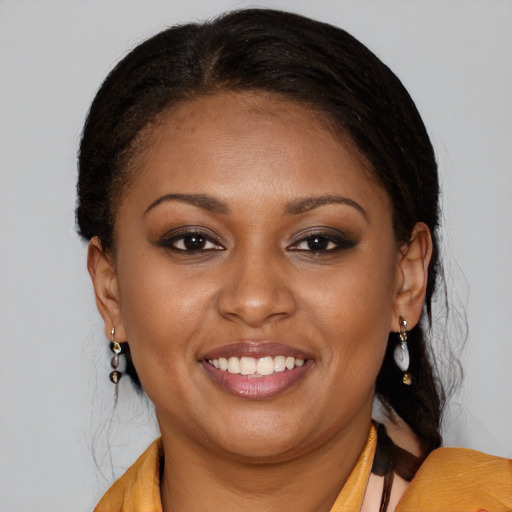 Joyful black young-adult female with medium  brown hair and brown eyes