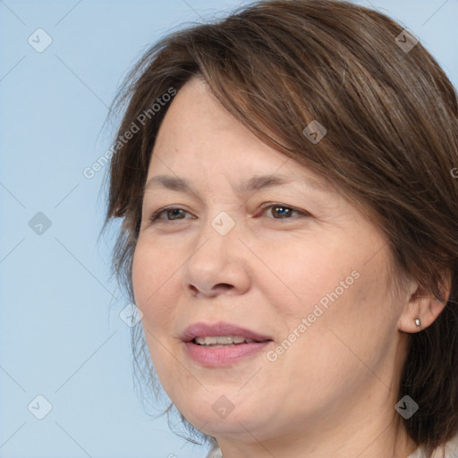 Joyful white adult female with medium  brown hair and brown eyes