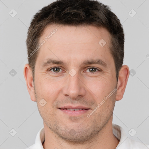 Joyful white adult male with short  brown hair and brown eyes