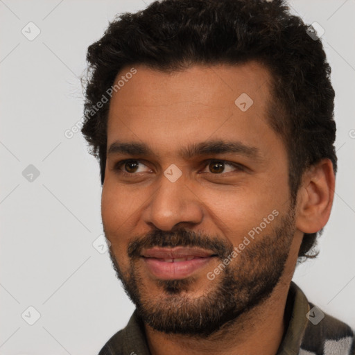 Joyful black young-adult male with short  black hair and brown eyes