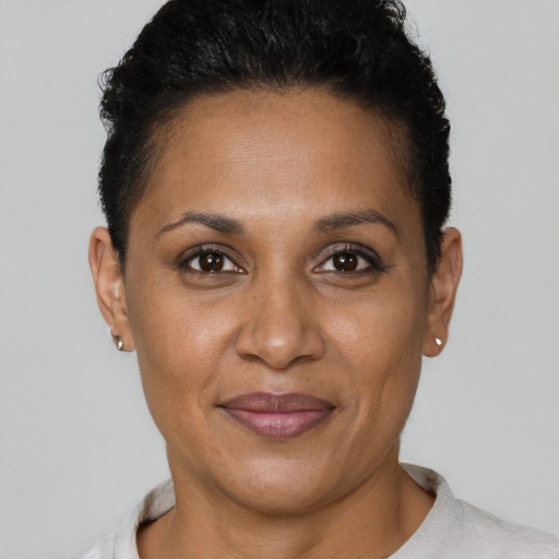 Joyful black adult female with short  brown hair and brown eyes