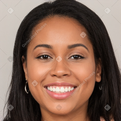 Joyful latino young-adult female with long  brown hair and brown eyes