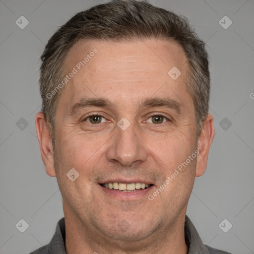 Joyful white adult male with short  brown hair and brown eyes