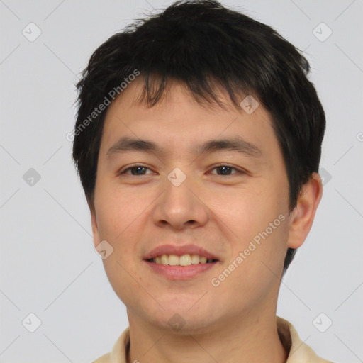 Joyful asian young-adult male with short  brown hair and brown eyes