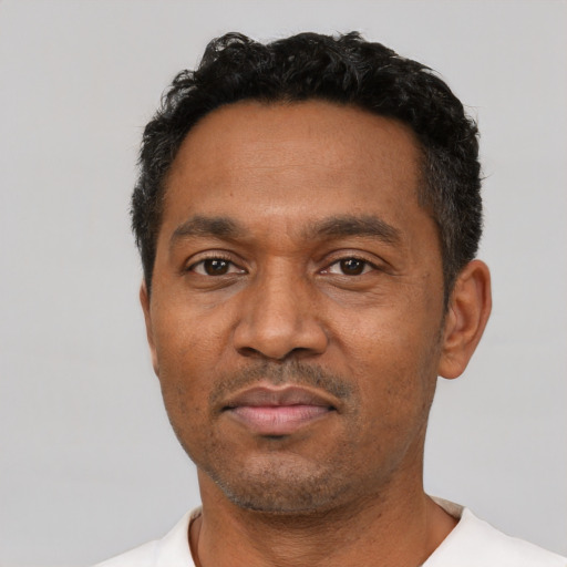 Neutral latino adult male with short  black hair and brown eyes