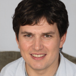 Joyful white adult male with short  brown hair and brown eyes