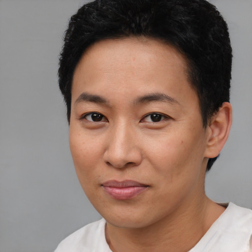 Joyful asian young-adult female with short  black hair and brown eyes