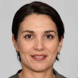 Joyful white adult female with medium  brown hair and brown eyes