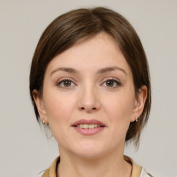 Joyful white young-adult female with medium  brown hair and grey eyes